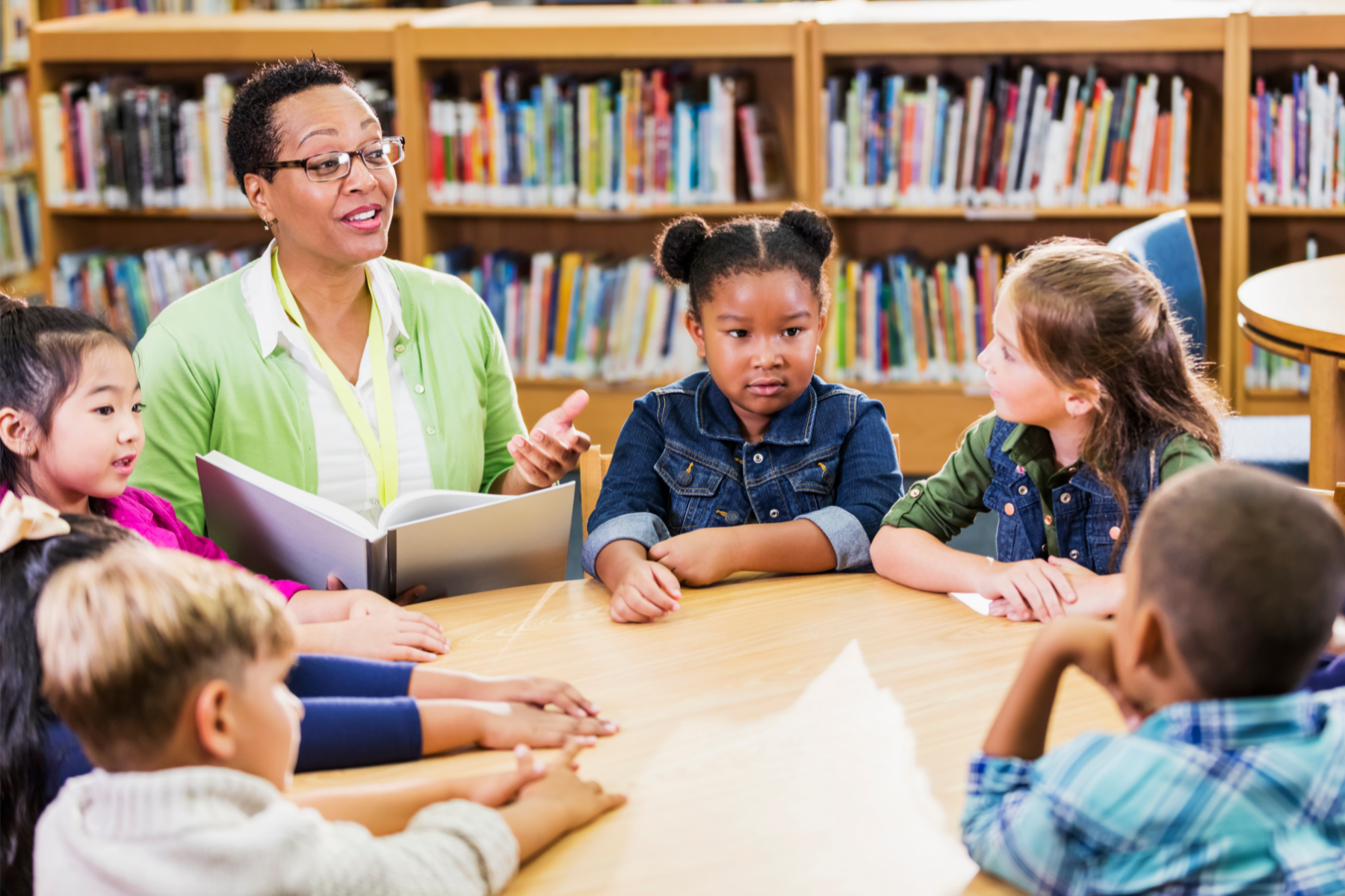 A teacher running a guided reading session with pupils